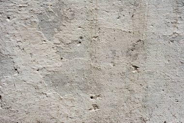Çatlakları ve çizikleri olan beton bir duvarın dokusu arka plan olarak kullanılabilir.