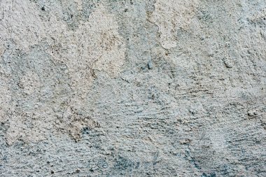Çatlakları ve çizikleri olan beton bir duvarın dokusu arka plan olarak kullanılabilir.