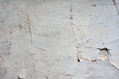 Çatlakları ve çizikleri olan beton bir duvarın dokusu arka plan olarak kullanılabilir.