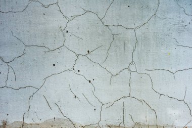 Çatlakları ve çizikleri olan beton bir duvarın dokusu arka plan olarak kullanılabilir.