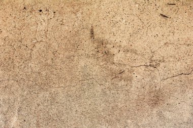 Çatlakları ve çizikleri olan beton bir duvarın dokusu arka plan olarak kullanılabilir.