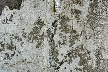 Çatlakları ve çizikleri olan beton bir duvarın dokusu arka plan olarak kullanılabilir.