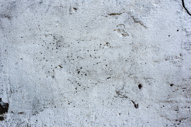 Çatlakları ve çizikleri olan beton bir duvarın dokusu arka plan olarak kullanılabilir.