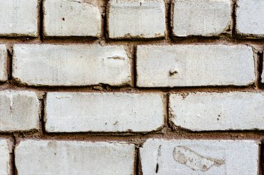 Çatlakları ve çizikleri olan tuğla duvar dokusu arka plan olarak kullanılabilir.