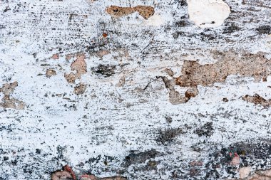 Çatlakları ve çizikleri olan tuğla duvar dokusu arka plan olarak kullanılabilir.