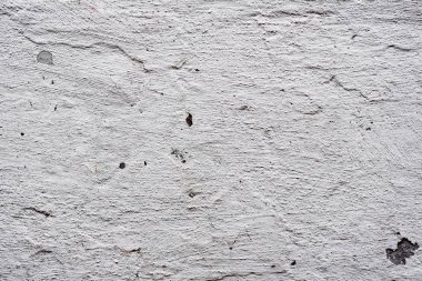 Çatlakları ve çizikleri olan beton bir duvarın dokusu arka plan olarak kullanılabilir.