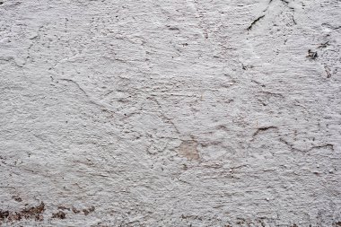Çatlakları ve çizikleri olan beton bir duvarın dokusu arka plan olarak kullanılabilir.