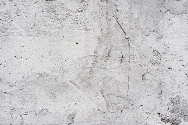 Çatlakları ve çizikleri olan beton bir duvarın dokusu arka plan olarak kullanılabilir.