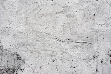 Çatlakları ve çizikleri olan beton bir duvarın dokusu arka plan olarak kullanılabilir.