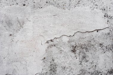 Çatlakları ve çizikleri olan beton bir duvarın dokusu arka plan olarak kullanılabilir.