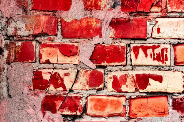 Red Brick wall for background or texture. Weathered texture of stained old dark brown and red brick