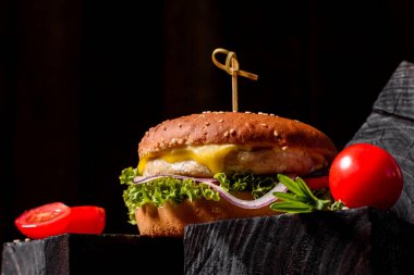Marul ve peynirli ev yapımı hamburger. Ev yapımı hamburgerler ahşap masada.