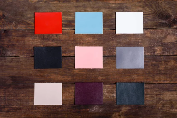 Colored pieces of leather samples for the manufacture of various products laid out in the form of a frame with space for text