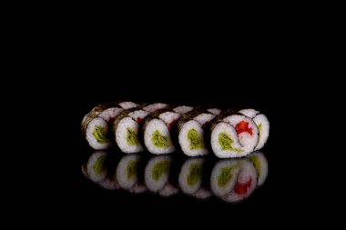 Karanlık bir arka planda taze, lezzetli suşi ruloları. Japon mutfağının elementleri