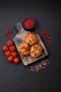 Lezzetli taze kıymalı balık pirzolası. Esmer arka planda baharatlar ve otlarla birlikte.