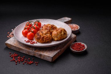 Lezzetli taze kıymalı balık pirzolası. Esmer arka planda baharatlar ve otlarla birlikte.