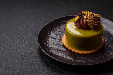 Fıstıklı kek ya da üzeri fındıklı yeşil krema ve meyve dolgulu turta. Tasarımınız için yemek arkaplanı olarak fıstıklı turta