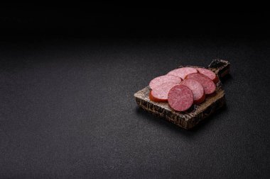 Dilimlenmiş salam sosisi, yiyecek olarak kurutulmuş et. Şenlik masası için dilimlenmiş salam sosisli antipasto.
