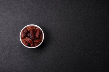 Seramik tabakta kurutulmuş hurmalar, ramazan tabağı için Arapça yiyecekler. Kurumuş tarihler tasarımın için bir yemek arkaplanı olarak kullanılacak..