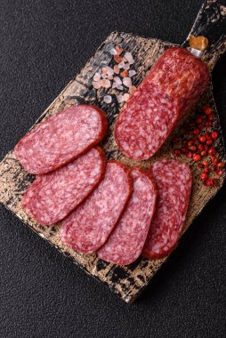 Sliced salami sausage, smoked meat as a delicacy for the table. Salami sausage as a food background for your design.