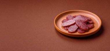 Sliced salami sausage, smoked meat as a delicacy for the table. Salami sausage as a food background for your design.
