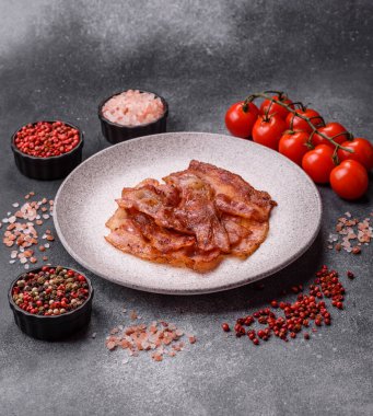 Fried pork bacon slices or strips as a breakfast ingredient. Fried bacon as a food background for your design