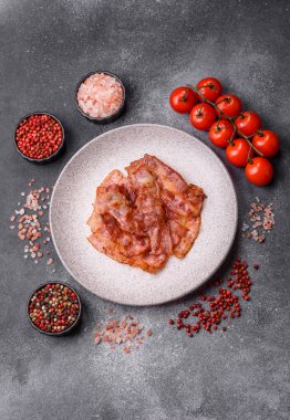 Fried pork bacon slices or strips as a breakfast ingredient. Fried bacon as a food background for your design