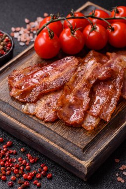 Fried pork bacon slices or strips as a breakfast ingredient. Fried bacon as a food background for your design