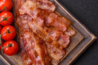 Fried pork bacon slices or strips as a breakfast ingredient. Fried bacon as a food background for your design