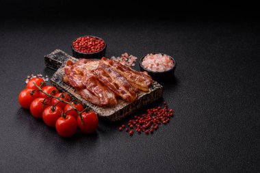 Fried pork bacon slices or strips as a breakfast ingredient. Fried bacon as a food background for your design