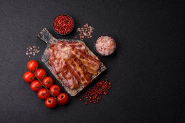 Fried pork bacon slices or strips as a breakfast ingredient. Fried bacon as a food background for your design