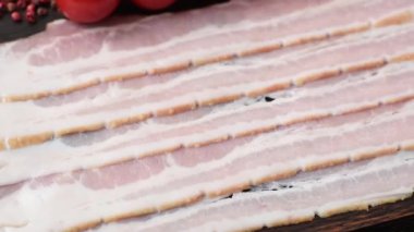 Raw or smoked pork bacon slices or strips as a breakfast ingredient. Raw bacon as a food background for your design.