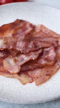 Fried pork bacon slices or strips as a breakfast ingredient. Fried bacon as a food background for your design