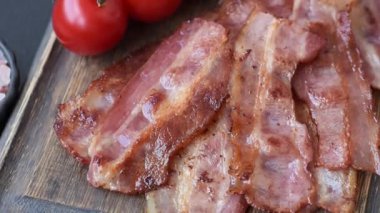 Fried pork bacon slices or strips as a breakfast ingredient. Fried bacon as a food background for your design