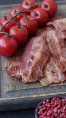Fried pork bacon slices or strips as a breakfast ingredient. Fried bacon as a food background for your design