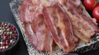 Fried pork bacon slices or strips as a breakfast ingredient. Fried bacon as a food background for your design