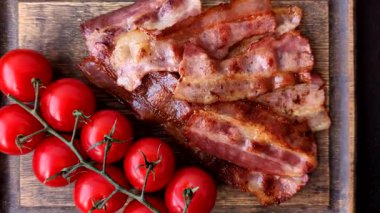 Fried pork bacon slices or strips as a breakfast ingredient. Fried bacon as a food background for your design