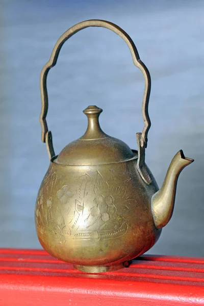 old vintage red teapot, Moroccan and Turkish tea in mind, golden object typical of the world and of the Arab tradition