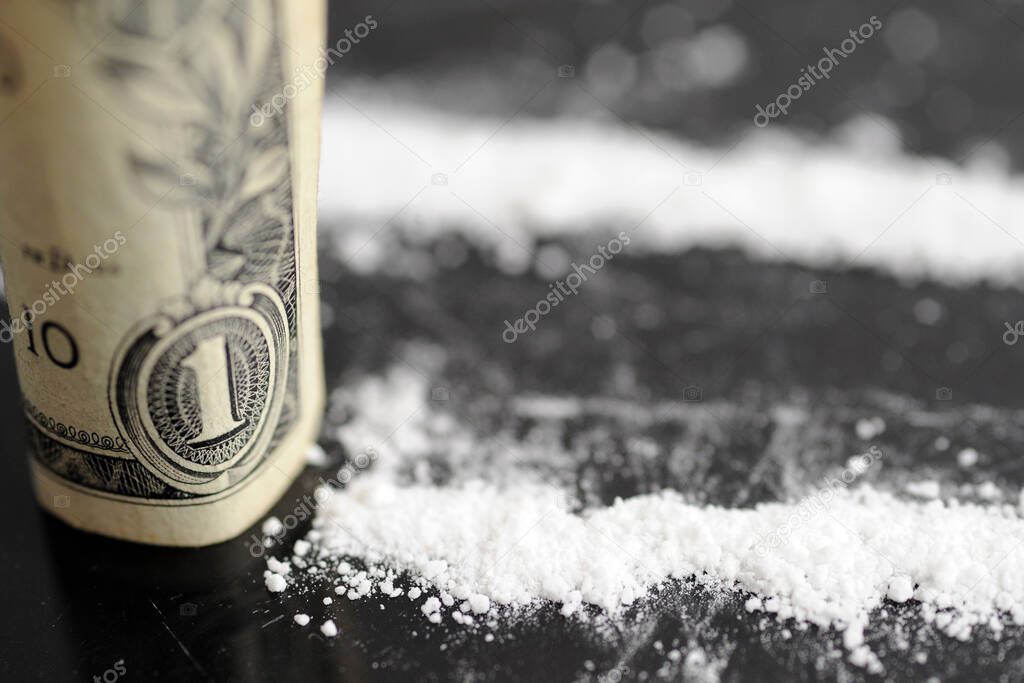 cocaine with us dollars banknotes, addiction and substance abuse concept