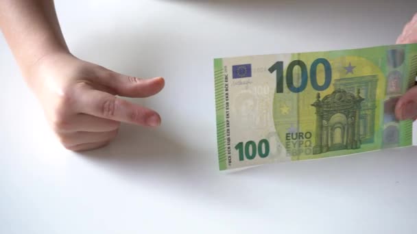 祖父母と孫祖母の手によって子供に100ユーロの現金紙幣が渡されます — ストック動画