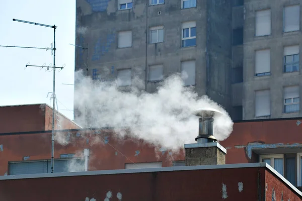 Italy, Milan, smog pollution, chimney smoke caused by heating the houses