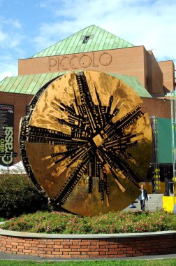 Milan, Italy - November 08, 2018: Paolo Grassi Teather Strehler - Piccolo teatro di Milano with the sculpture of Pomodoro clipart