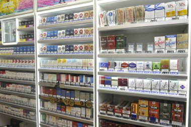 Italy - Milan may 5,2018 - tobacconist - tobacco and cigarette packs of various brands on display for sale - tax increase on smoking clipart