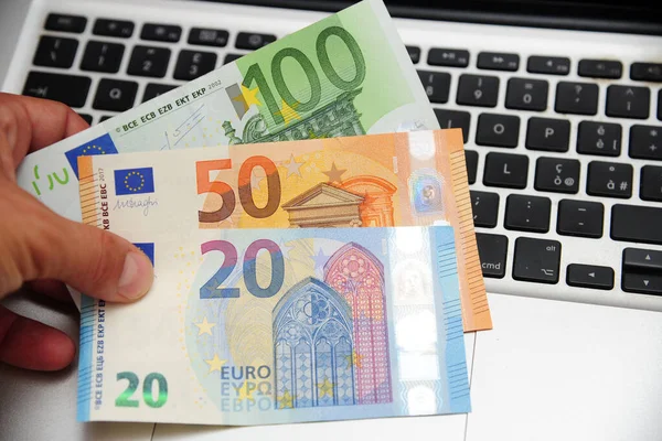 euro money and computer keyboard - economic transaction and bank on line