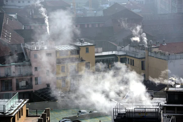 Italy, Milan, smog pollution, chimney smoke caused by heating the houses