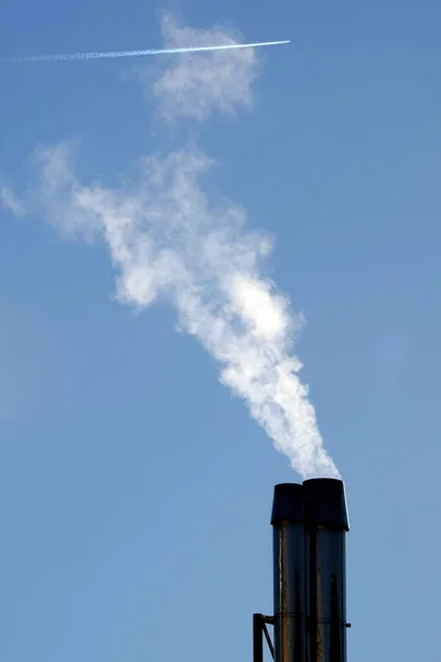 Italy, Milan, smog pollution, chimney smoke caused by heating the houses