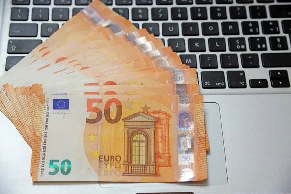 euro money and computer keyboard - economic transaction and bank on line