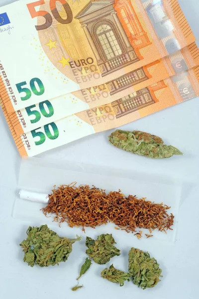 cannabis ( weed ) to be smoked ( thc and cbd ) - marjuana flower and hashisc - smoke addiction and drug illegal with euro money - healing herb