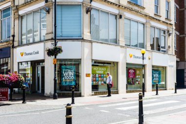 Trowbridge Wiltshire şehir merkezinde seyahat acenteleri Thomas Cook 'un camından bakan bir adam.