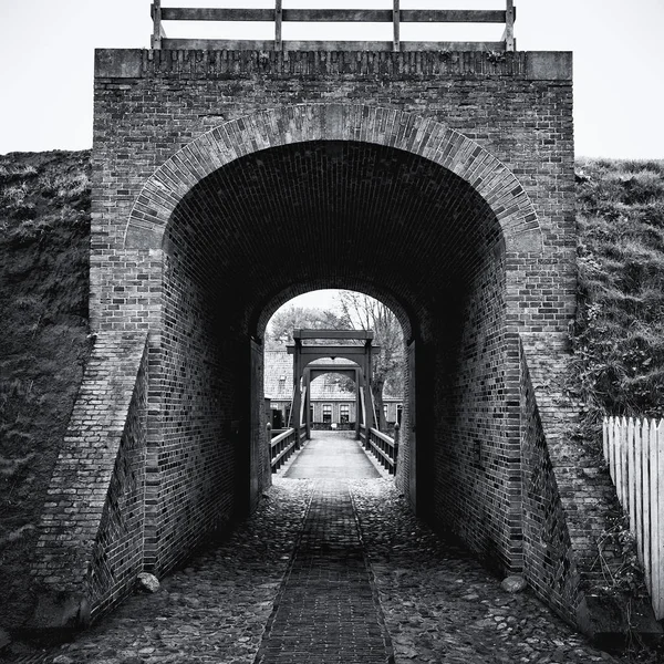 Black and white picture of the access bridge to Bourtange, a Dutch fortified village in the province of Groningen  in the north of the Netherlands